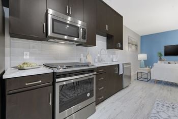 Stainless steel appliances including built-in microwave, refrigerator, and dishwasher